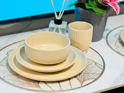 two bowls and plates on a glass plate on a table at Shore 2 Residences Room 360 POOL VIEW by Prime Stay MOA in Manila