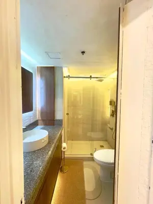 a bathroom with a sink and a toilet and a shower at Taguig, near BGC Staycation in Manila
