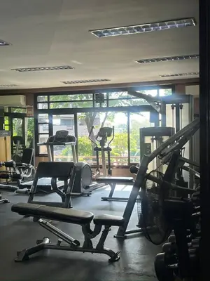 a gym with lots of exercise equipment in a room at Taguig, near BGC Staycation in Manila