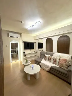 a living room with a couch and a table at Taguig, near BGC Staycation in Manila