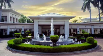 a large building with a fountain in front of it at Stunning flat in Alabang in Manila