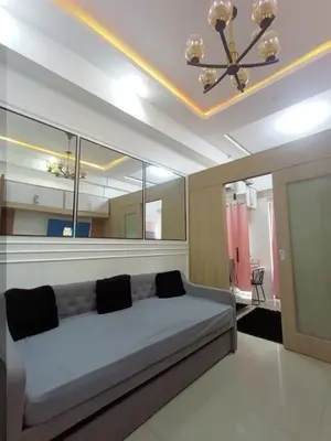 a living room with a couch and a ceiling at Cozy Couple Room near mall of asia in Manila