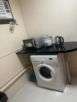 a table with a washing machine in a room at Cozy Avant BGC 1Br Sleeps 4 in Manila