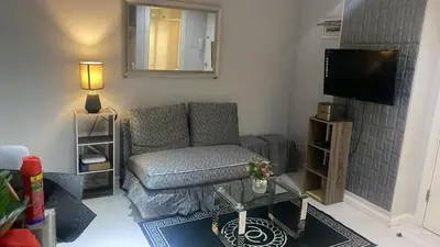 a living room with a couch and a television at 2bedroom azure beach 5 in Manila