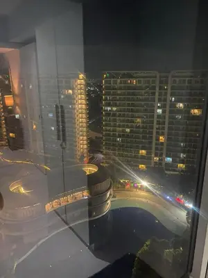 a view of a city at night from a building at 2bedroom azure beach 5 in Manila
