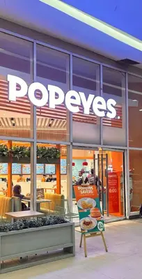 a pepys store with a sign in front of it at Cozy Makati 2BR in CBD Ayala area with games, KTV, and Amazing Pools! in Manila
