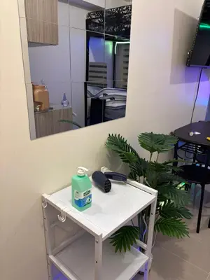 a white table with a phone and a mirror at Urban Deca Tower Cubao - Affordable Condo Unit for Transient in Manila