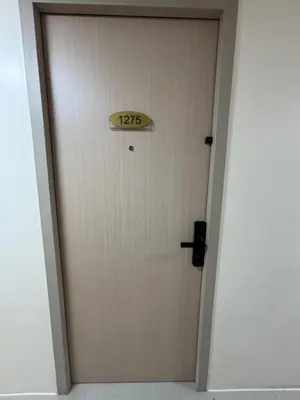 a door with a sign on it in a hallway at Urban Deca Tower Cubao - Affordable Condo Unit for Transient in Manila