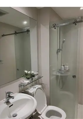 a bathroom with a toilet and a sink and a shower at Azure Staycation by Leojen in Manila