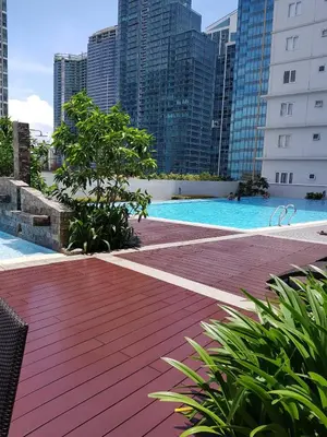 a swimming pool in a city with tall buildings at 1BR-unit in central BGC in Manila