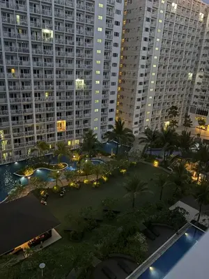 a view of a courtyard with palm trees and buildings at Azul Paradise in Manila