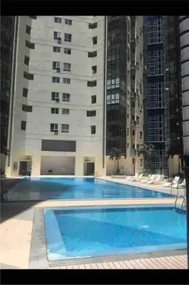 a large swimming pool in front of a building at 2BR Loft at Fort Victoria Condominium BGC in Manila