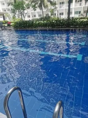 a swimming pool with blue water in front of a building at Azul Paradise in Manila