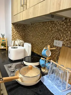a kitchen with a counter top with a stove top at Azul Paradise in Manila