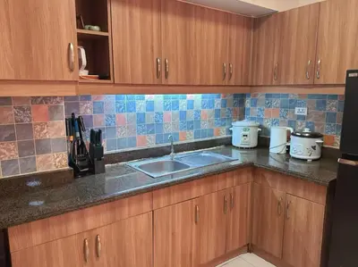 a kitchen with a sink and a counter top at torre de manila taft luneta park view in Manila