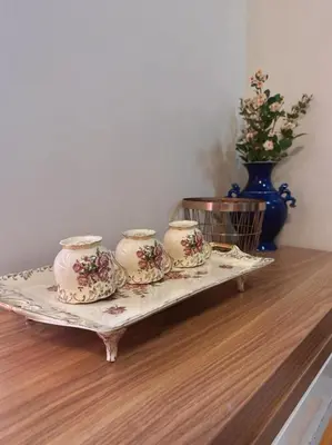 a tray with four tea cups sitting on a table at Family Rooms with View in Manila