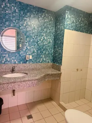 a bathroom with a sink and a mirror at Family Rooms with View in Manila