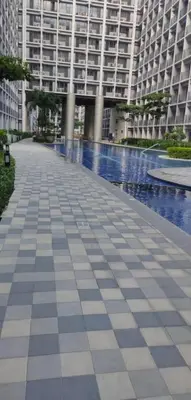 a large building with a tiled walkway in front of it at Shore Residences in Manila