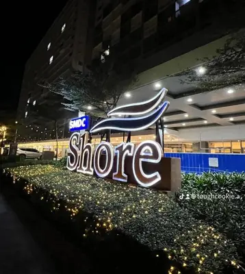 a large sign for a store at night at Staycation in Shore Residences, walking distance to MOA and near Manila Airport in Manila