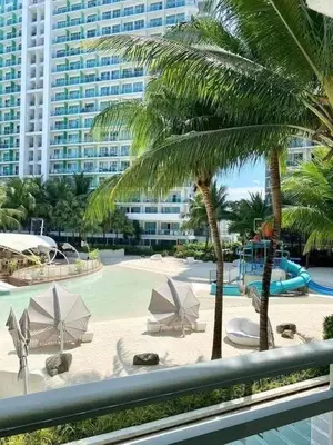 a view of a resort with a pool and palm trees at SM Bicutan Boracay Tower in Manila