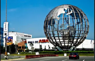 a large metal sphere sitting on the side of a road at Legit Staycation walking distance to Mall of Asia located in Shore1 and 2 Residences in Manila