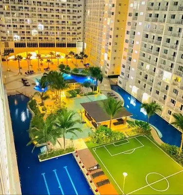 an aerial view of a resort with a tennis court at Legit Staycation walking distance to Mall of Asia located in Shore1 and 2 Residences in Manila