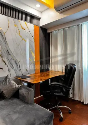 a office with a desk and a chair and a couch at Modern Comfort at MOA Shore 3 in Manila