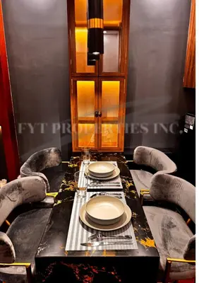 a dining room table with chairs and plates on it at Modern Comfort at MOA Shore 3 in Manila