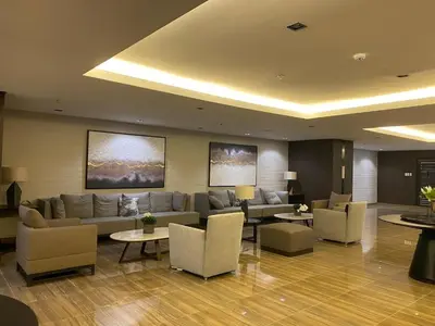 a living room with a couch and chairs and tables at Solace Haven in Manila