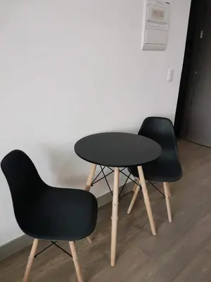 two black chairs and a table in a room at Luxury Condo at Century Spire in Central Makati in Manila