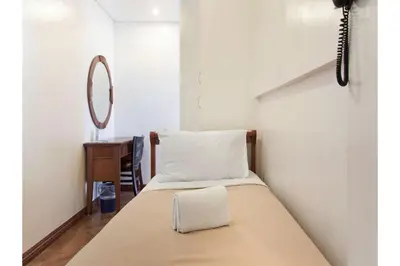 a bedroom with a bed with a mirror on the wall at Belvilla Airport Stays Near Makati Manila Formerly Avitel Hotel in Manila