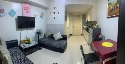 a living room with a couch and a table at Zion Staycation at Sea Residences in Manila