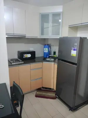 a kitchen with a refrigerator and a microwave at Rqui Condotel at Newport Pasay City in Manila