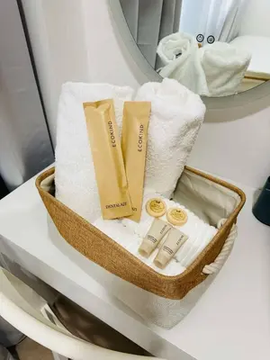 a basket filled with towels and toiletries on an airplane at Larsie's Place in Manila