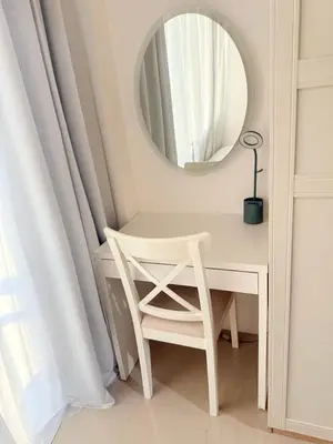 a white desk with a chair and a mirror at Larsie's Place in Manila
