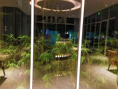 a room with plants inside of a building at Condo Free Pool Fast Wi-fi near BGC, C5 in Manila