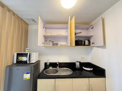 a small kitchen with a sink and a microwave at Manila Korea Town Seaview and City View Staycation in Manila