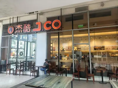 a person sitting at a table in front of a restaurant at Pristine Hotel in Manila