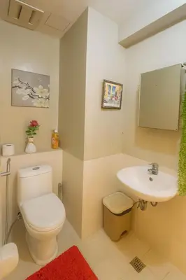 a bathroom with a toilet and a sink at La Suitez 1421 l Sky Studio l 360 City l Sea View in Manila
