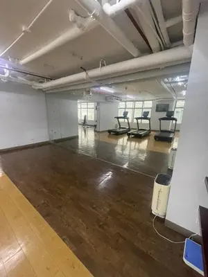 an empty room with a gym with chairs in it at Makati City Antel Spa Residences 1615 in Manila