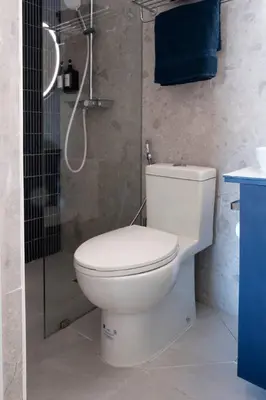 a bathroom with a toilet and a shower at BGC Designer Pad Near Shops Dining Nightlife in Manila