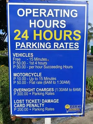a sign for a hours parking rates at Len's Den 3 Entire Flat in Mall of Asia Pasay Manila in Manila