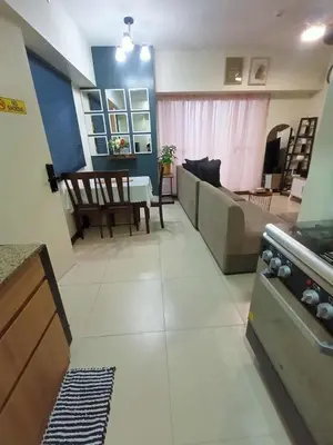 a living room with a couch and a table at Family-Ready Skyline Retreat near BGC with Free Parking in Manila