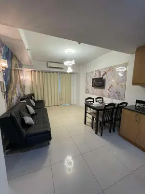 a living room with a couch and a table at 1158-2Br 6beds 2 extra mattress 2-sofa in Manila