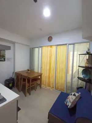 a living room with a table and a dining room at azure beach front view in Manila