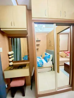 a doll house with a mirror and a bedroom at 1528-1br-1bed-1sofa bed 1pull out pool view with balcony in Manila