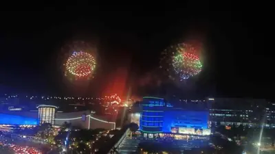 two fireworks in the sky over a city at night at 1058-3br-10 beds 1 extra mattress-moa view with balcony in Manila