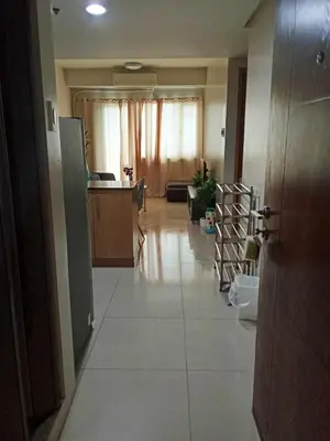 a hallway of a home with a kitchen and a living room at 1046-2Br 2bed 1extra matress pool view with balcony in Manila