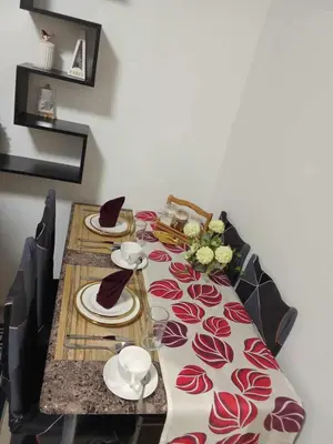 a table with a table cloth with hats on it at 241-1br -1bed 1 extra mattress in Manila