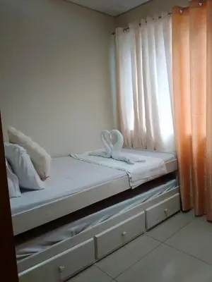 a bed with a pair of swans sitting on it at 101-2Br-1bed quenn-1single-1-pullout 2 sofa 2-cr pool view with balcony in Manila